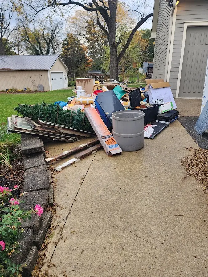 Dumpster being loaded with debris for Roofing Dumpster Rental in Brightwaters